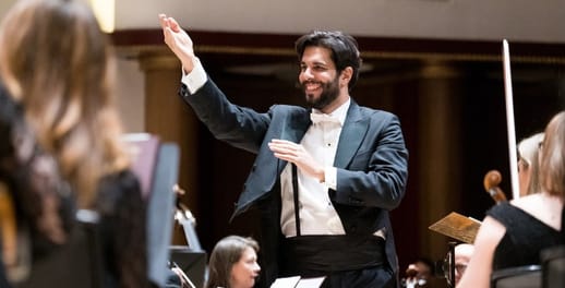 The conductor of the Royal Liverpool Philharmonic conducts the orchestra
