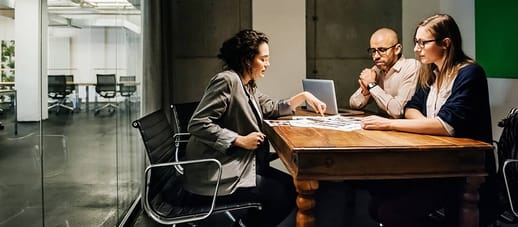 Three people in a meeting in an office