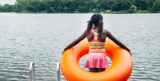 Young girl in a large inflatable orange ring