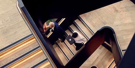 two businessmen walking down stairs
