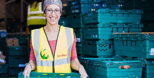 Fareshare volunteer moving a box of fruit