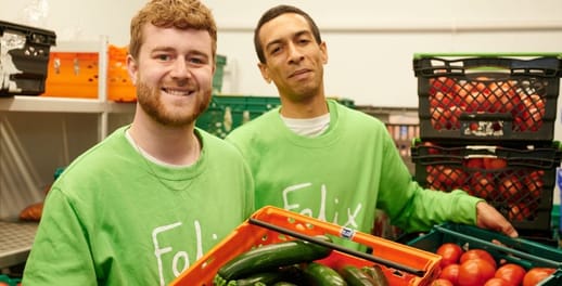 Felix project volunteers moving crates of vegetables