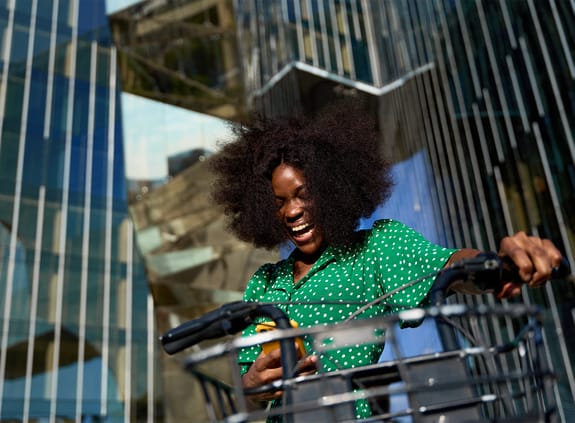 Woman on bike in business district