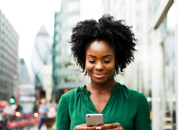 Business woman in green shirt on phone in the City of London