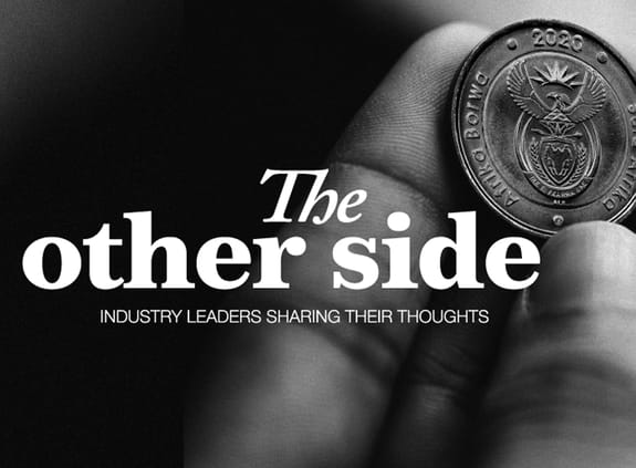 The Other Side: hand holding a coin
