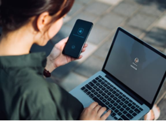 lady on laptop and phone