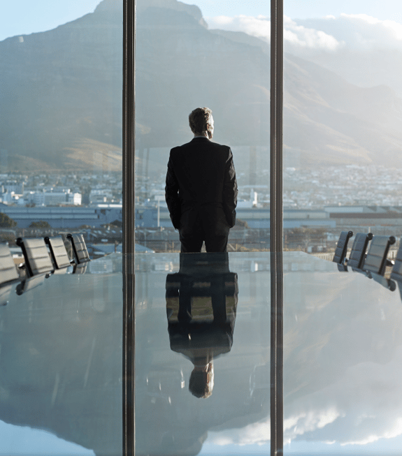 man-in-boardroom-with-view-of-mountain