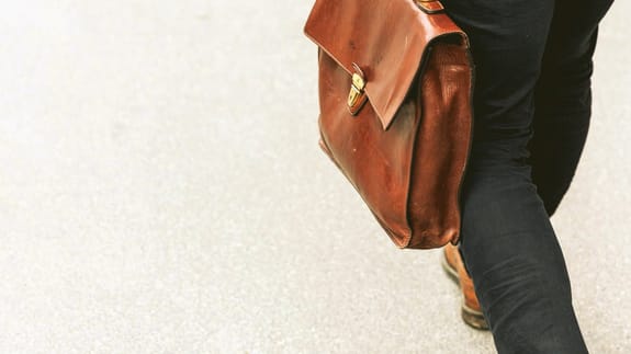 guy carrying notes in briefcase