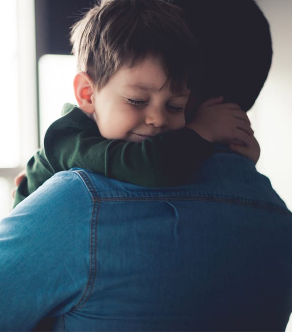 young boy hugging his father