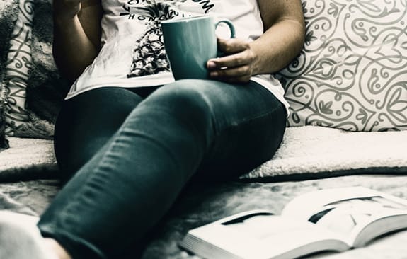 young female sitting on pillows