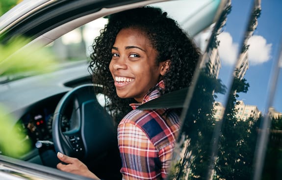 young professional in her new car