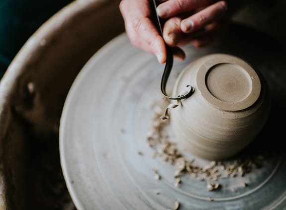 Making a cup in on a pottery wheel