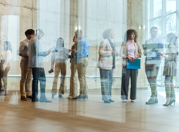 People meeting while waiting in a building foyer