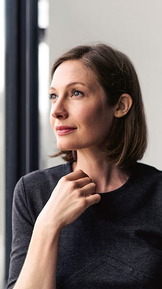 Lady sitting staring out office window