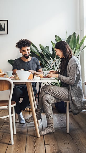 Young couple enjoying breakfast at home