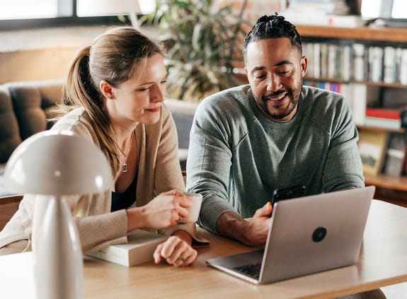 couple looking on laptop for bank accounts