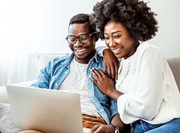 Couple looking at their bank account on a laptop