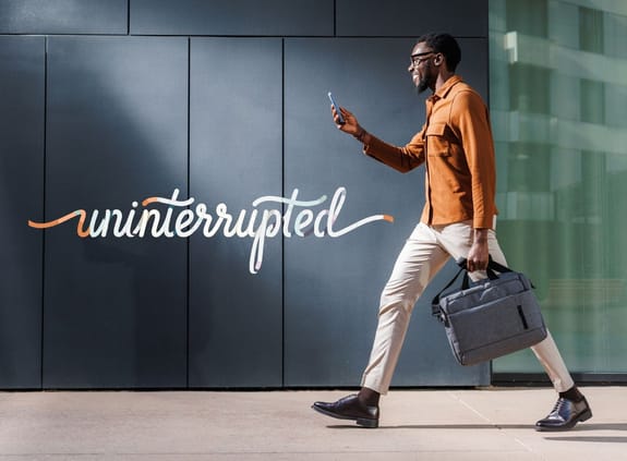 Man walking looking at phone