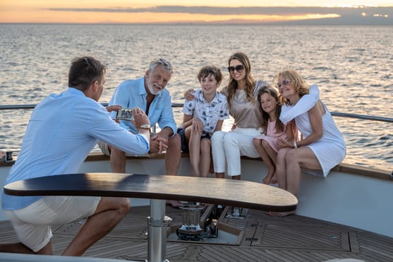 Family taking photograph on yacht