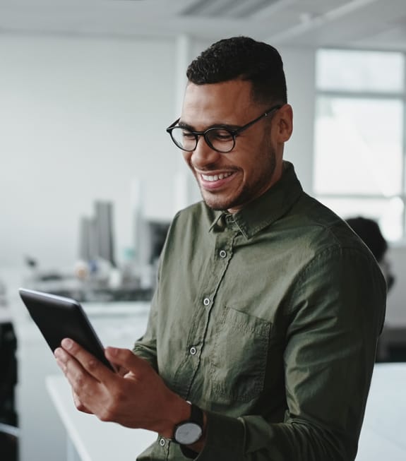 Young professional bank account | young man on their tablet in the office