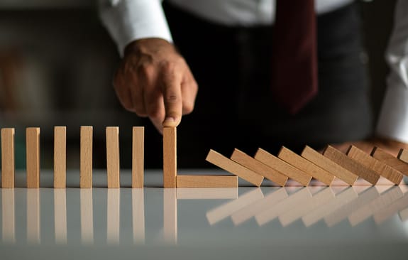 Businessman Stop Domino Effect