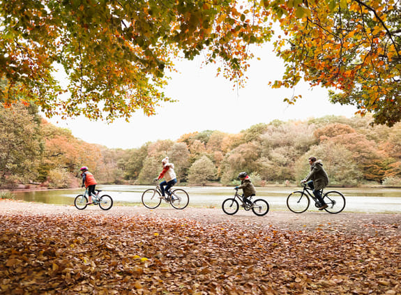 family cycling through woodland park