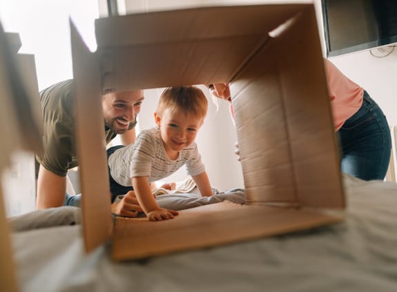 boy crawling through cardboard box