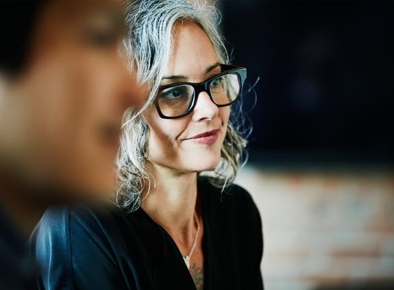 Smiling businesswoman listening during team meeting