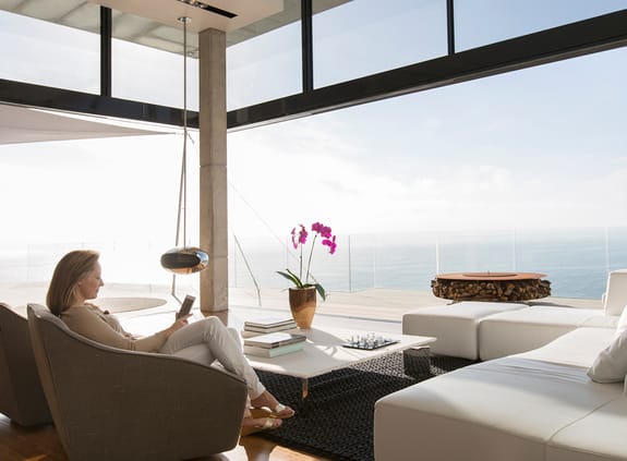 Lady relaxing in her sun lounge overlooking the ocean