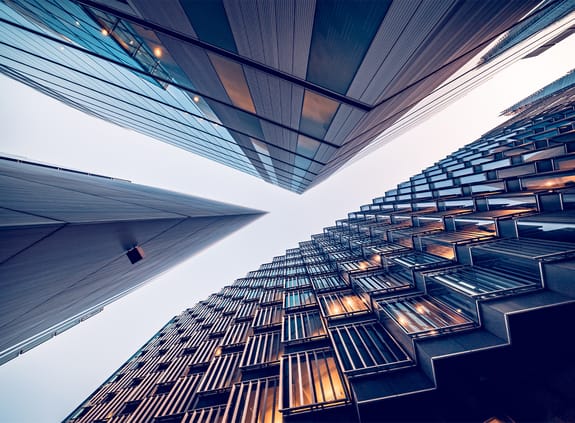 Looking directly up at the skyline of the financial district in central London