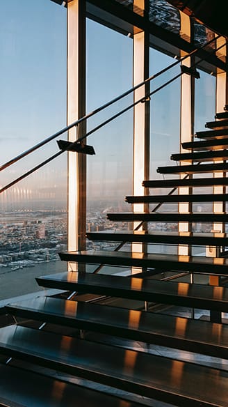 Inside of a high-end building, with a view over the city