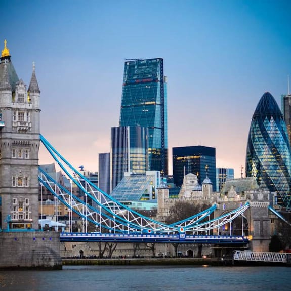 Looking across London's River Thames at sunset towards the skyscrapers of the square mile