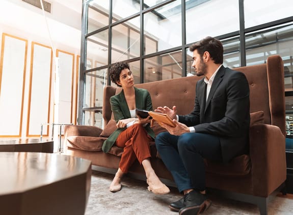 Man and woman meeting while sitting on a sofa