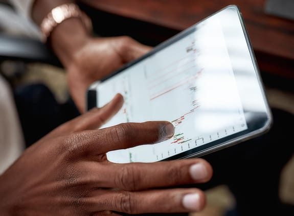 An investor views a stock chart on their tablet