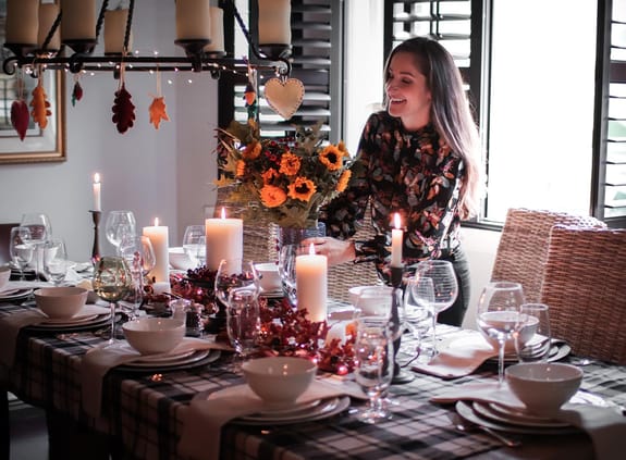 Woman dressing a dining room table