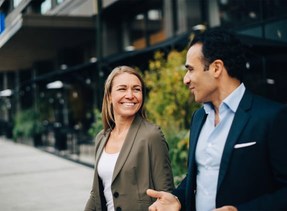 finance professionals chatting while walking outside
