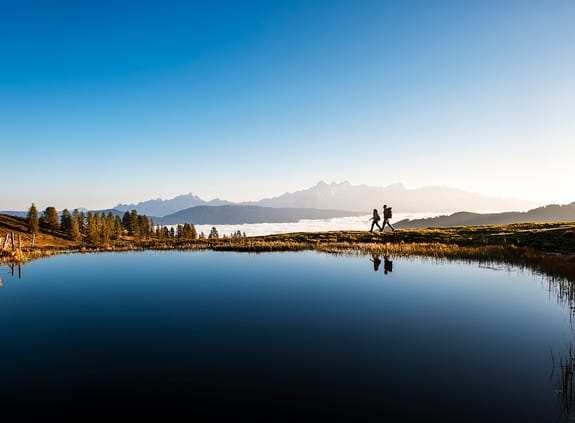 Two people crossing an elevated landscape