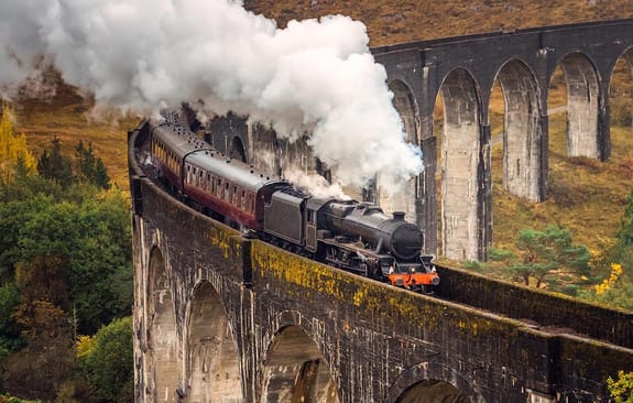 Train steaming across a viaduct