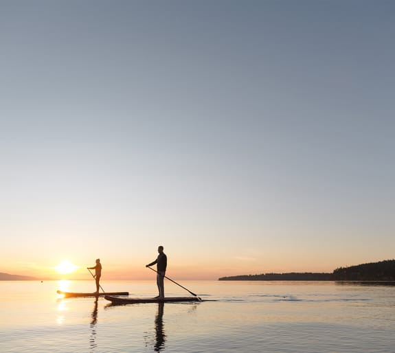 paddle boarders on a lake