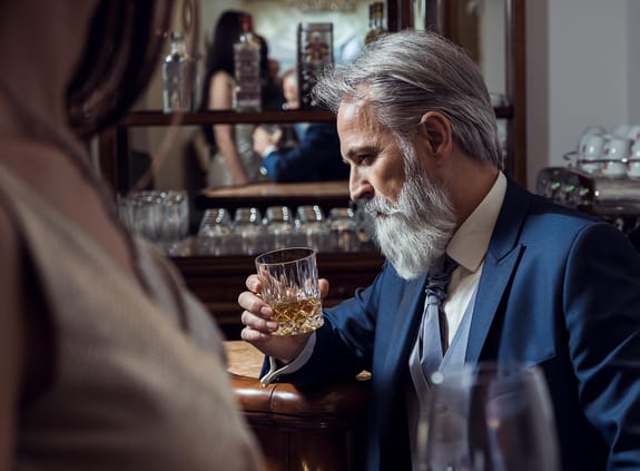 Man holding a glass of whisky