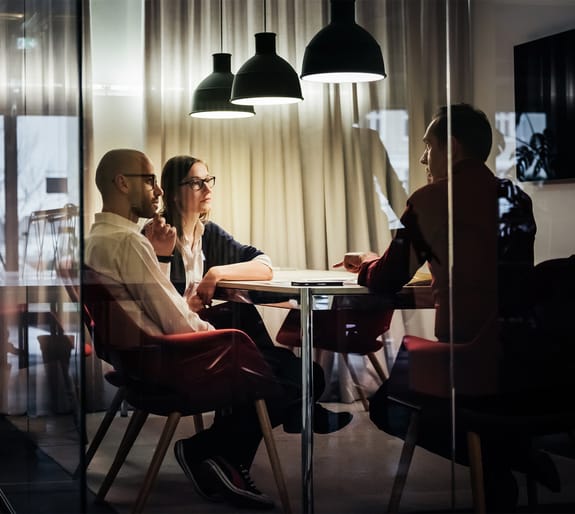 advisor speaking with customers in a meeting room