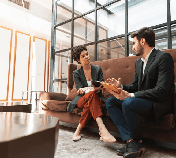 A couple talking in depth, in a business setting
