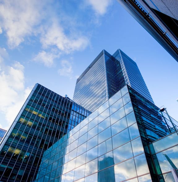 Glass corporate buildings looking skyward
