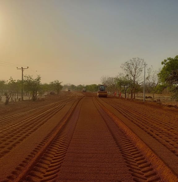 A new road being laid in Ghana, with graders and rollers at work