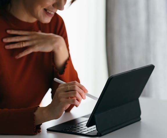 A lady reads a report on her tablet in the office