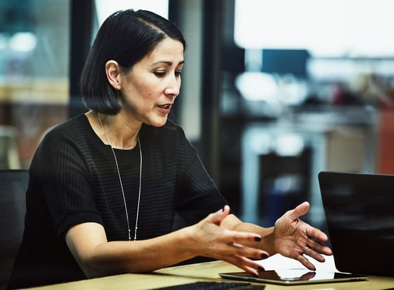 Businesswoman explaining data on digital tablet during meeting in office conference room