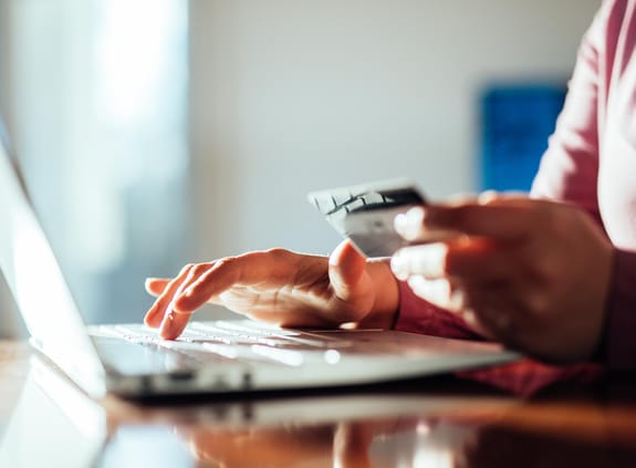 Woman shopping online with a credit card