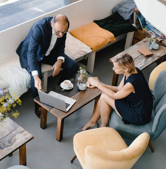 A man and a woman having a business meeting over a coffee