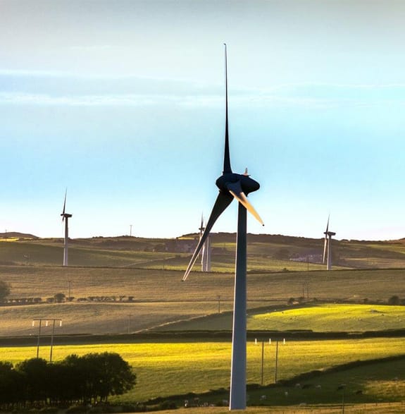 A wind turbine turning in a field