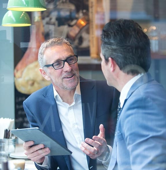 A financial adviser meeting with his client in a cafe